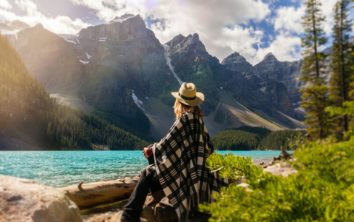 A woman sits on a rock beside the lake 2916820